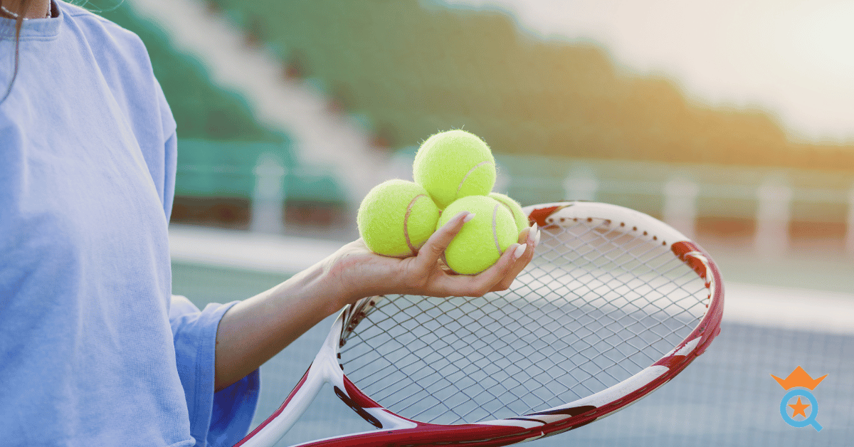 tennis player holding three tennis balls