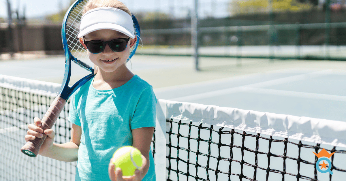 kid holding a tennis ball