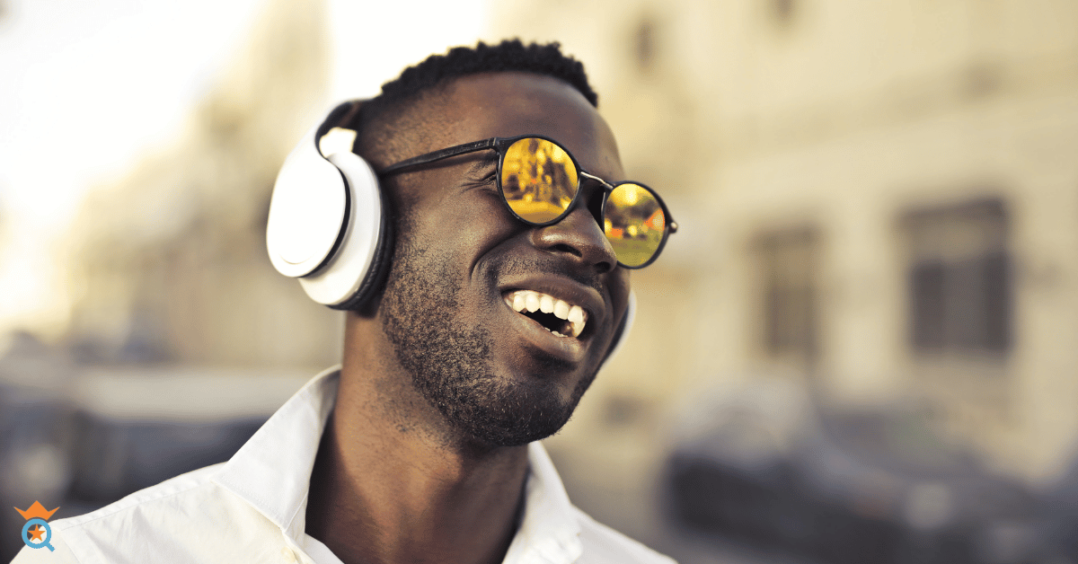 Black guy wearing white headphone smiling
