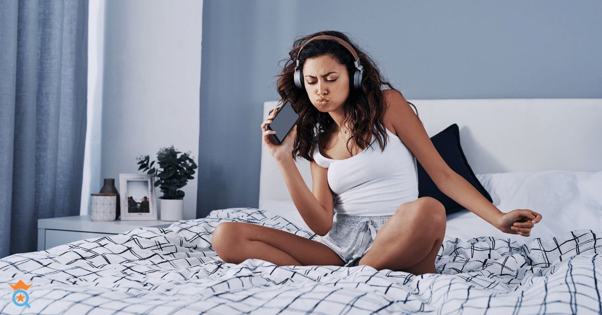 girl wearing headphone in the bed