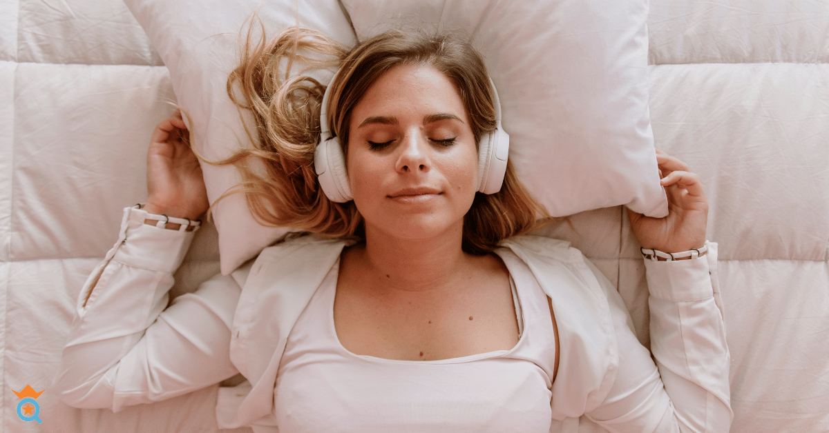 girl lying in bed wearing headphone